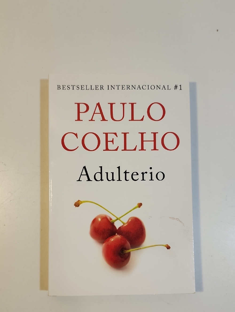 Paulo Coelho Adulterio - White Cover with Red Cherry Artwork Spanish